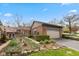 Charming brick home with a two-car garage and beautifully landscaped front yard with stone accents at 5333 Thicket Hill Ln, Indianapolis, IN 46226