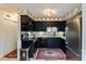 Kitchen with black cabinets, stainless steel appliances, a stone backsplash and pendant lighting at 5333 Thicket Hill Ln, Indianapolis, IN 46226