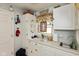 Charming laundry room featuring white cabinets, decorative accents, and a window at 5333 Thicket Hill Ln, Indianapolis, IN 46226