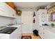 Well-organized laundry room featuring a washer, dryer, and ample cabinet storage at 5333 Thicket Hill Ln, Indianapolis, IN 46226