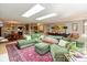 Bright living room featuring skylights, a large sectional couch, and an oriental rug at 5333 Thicket Hill Ln, Indianapolis, IN 46226