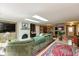 Spacious living room with a white brick fireplace, skylights and an adjacent dining room at 5333 Thicket Hill Ln, Indianapolis, IN 46226
