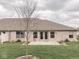 Backyard with lawn, patio, brick exterior, and a sliding glass door for indoor-outdoor living at 5524 Coventry Park Way, Indianapolis, IN 46237