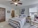 Comfortable bedroom with a ceiling fan, neutral carpet, and a side table at 5524 Coventry Park Way, Indianapolis, IN 46237