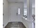 Inviting entryway featuring hardwood floors, white trim, and an attractive front door with a security system at 5524 Coventry Park Way, Indianapolis, IN 46237