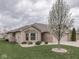 Exterior view of a well-kept home with a blossoming tree in the front yard at 5524 Coventry Park Way, Indianapolis, IN 46237