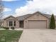 Charming single-story brick home featuring an attached two-car garage and well-maintained landscaping at 5524 Coventry Park Way, Indianapolis, IN 46237