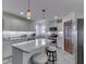 Well-lit kitchen boasting granite countertops, white cabinetry, stainless steel appliances, and modern pendant lights at 5524 Coventry Park Way, Indianapolis, IN 46237