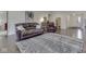Cozy living room featuring hardwood floors, a comfortable leather sofa, and ample space for relaxation at 5524 Coventry Park Way, Indianapolis, IN 46237