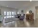 Open concept living room featuring hardwood floors, comfortable seating, and abundant natural light at 5524 Coventry Park Way, Indianapolis, IN 46237