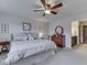 Bedroom featuring neutral tones, a ceiling fan, and an adjacent bathroom at 5524 Coventry Park Way, Indianapolis, IN 46237