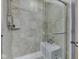 Shower with neutral tile, a seat and glass door with overhead shower fixture at 5524 Coventry Park Way, Indianapolis, IN 46237