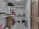 Well-organized walk-in closet with shelving, hanging rods and unique decorative items at 5524 Coventry Park Way, Indianapolis, IN 46237