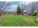 Expansive backyard featuring mature trees, shed, and plenty of green space at 5945 Mcfarland Rd, Indianapolis, IN 46227