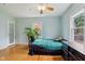 Well-lit bedroom with hardwood floors, a window, and a ceiling fan at 5945 Mcfarland Rd, Indianapolis, IN 46227