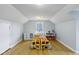 Attic bedroom with bright lighting, white walls, and wood floors at 5945 Mcfarland Rd, Indianapolis, IN 46227