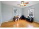 Cozy bedroom featuring hardwood floors, neutral walls, and plenty of natural light at 5945 Mcfarland Rd, Indianapolis, IN 46227