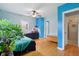 Spacious bedroom with hardwood floors, a ceiling fan, and ensuite bathroom access at 5945 Mcfarland Rd, Indianapolis, IN 46227
