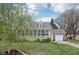 Charming home featuring a lush front yard, a lovely sunroom, and an attached one car garage at 5945 Mcfarland Rd, Indianapolis, IN 46227