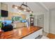 Well lit kitchen boasting stainless steel appliances, updated cabinets, and a breakfast bar at 5945 Mcfarland Rd, Indianapolis, IN 46227