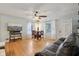 Inviting living room featuring hardwood floors, a ceiling fan, and modern windows that bring in natural light at 5945 Mcfarland Rd, Indianapolis, IN 46227