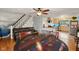 Open floor plan featuring hardwood floors, the kitchen, dining area, and a staircase at 5945 Mcfarland Rd, Indianapolis, IN 46227