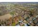 Aerial shot of the neighborhood surrounded by trees and the golf course in the background at 6436 E Hadley Rd, Mooresville, IN 46158