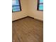 Corner bedroom featuring wood-look flooring, natural lighting, and updated trim at 7002 Mclain Dr, Indianapolis, IN 46217