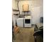 A utility area in a garage with a washer, dryer, shelving, and access door at 7002 Mclain Dr, Indianapolis, IN 46217