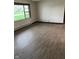 Living room showcasing wood-look floors and natural light with a large picture window at 7002 Mclain Dr, Indianapolis, IN 46217