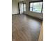Spacious living room features wood-look floors, large windows, and ample natural light at 7002 Mclain Dr, Indianapolis, IN 46217