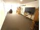 Spacious carpeted basement area with natural light and multiple built-ins at 709 Braugham Rd, Indianapolis, IN 46227