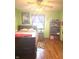 Comfortable bedroom with hardwood floors, natural light, and closet space at 709 Braugham Rd, Indianapolis, IN 46227
