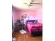 Inviting bedroom with hardwood floors, a desk area, and a comfortable bed at 709 Braugham Rd, Indianapolis, IN 46227