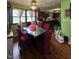 Open dining area with hardwood floors, dark wood cabinets in the kitchen, and a ceiling fan at 709 Braugham Rd, Indianapolis, IN 46227
