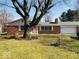 Charming single-story brick home with attached garage, mature tree in the front yard, and well-maintained lawn at 709 Braugham Rd, Indianapolis, IN 46227