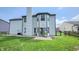 This backyard includes a large, well-manicured lawn and a home with light gray vinyl siding at 716 Bristol Ct, Greenwood, IN 46143