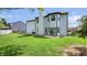 A well-maintained backyard features a large lawn, patio, and home with light gray vinyl siding at 716 Bristol Ct, Greenwood, IN 46143