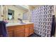 Bathroom featuring a double sink vanity, large mirror, and decorative shower curtain at 716 Bristol Ct, Greenwood, IN 46143