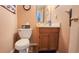 A compact bathroom with a toilet, vanity, and a well-lit mirror, offering functionality in a cozy space at 716 Bristol Ct, Greenwood, IN 46143