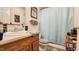 Cozy bathroom featuring a single sink vanity and a shower with a light blue shower curtain at 716 Bristol Ct, Greenwood, IN 46143