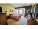 Comfortable bedroom with a bay window, dark accent wall, and a dresser with decorative items at 716 Bristol Ct, Greenwood, IN 46143