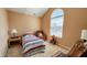 Bright bedroom featuring a comfortable bed, a cozy chair, and a vaulted ceiling at 716 Bristol Ct, Greenwood, IN 46143