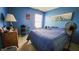 This bedroom offers a large bed, blue walls, natural lighting, and modern decor at 716 Bristol Ct, Greenwood, IN 46143