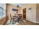 A charming dining area with a round table set for four, complemented by natural light and a decorative area rug at 716 Bristol Ct, Greenwood, IN 46143