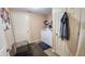 Functional laundry room with white appliances, wire shelving, and easy access to additional spaces at 716 Bristol Ct, Greenwood, IN 46143