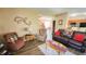 Comfortable living room featuring a leather sofa, recliner, and a glimpse into the adjacent dining area and staircase at 716 Bristol Ct, Greenwood, IN 46143