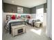 Charming ' bedroom featuring two beds, chalkboard chests, and modern decor with great natural light at 7282 Portico Ln, McCordsville, IN 46055