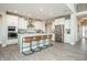 Spacious kitchen featuring a large island with seating, stainless steel appliances, and white cabinetry at 7282 Portico Ln, McCordsville, IN 46055