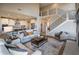 Spacious living room with fireplace, open floor plan, hardwood floors, staircase, and plenty of natural light at 7282 Portico Ln, McCordsville, IN 46055